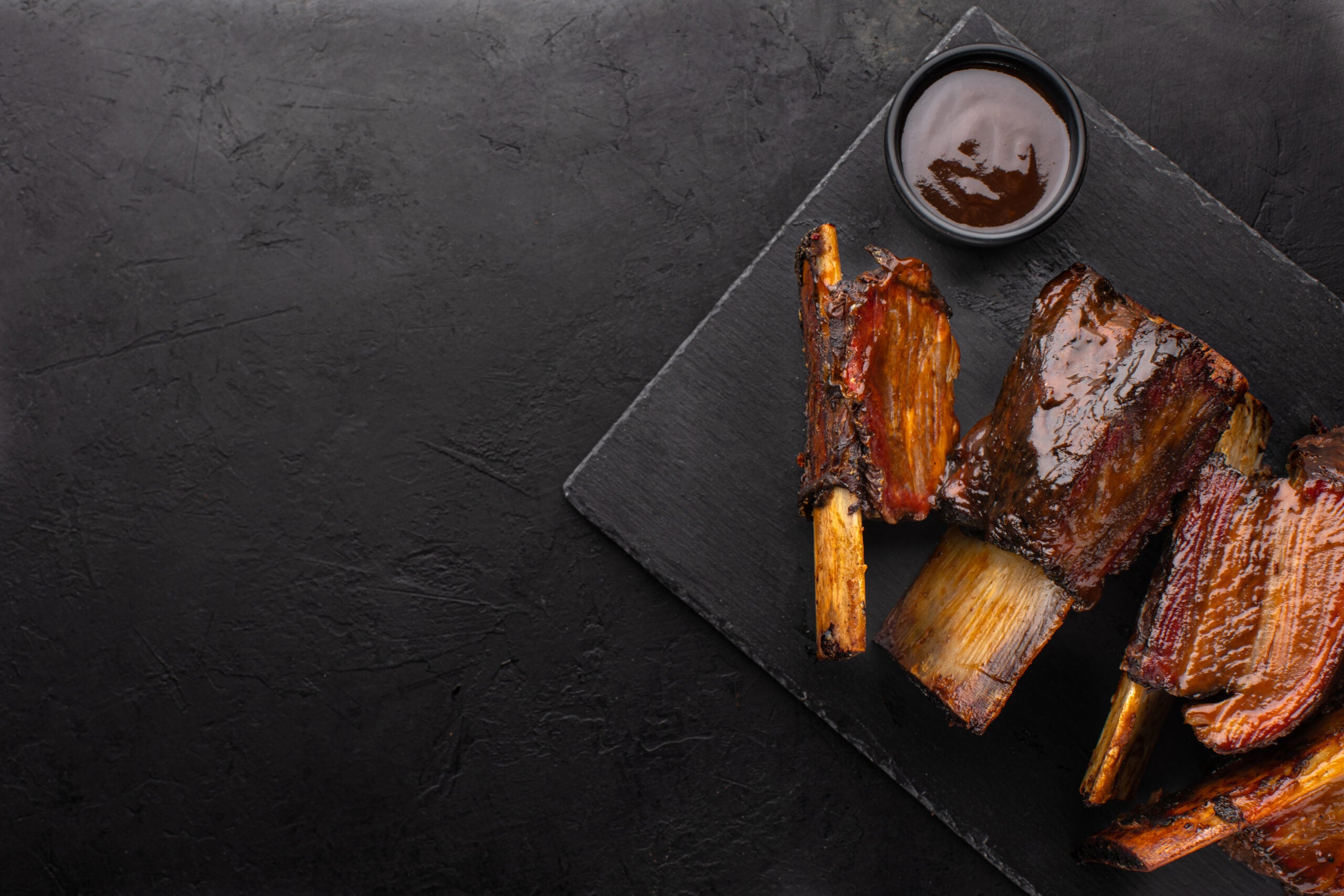 Roasted beef bones on a board, ready to go into the broth pot
