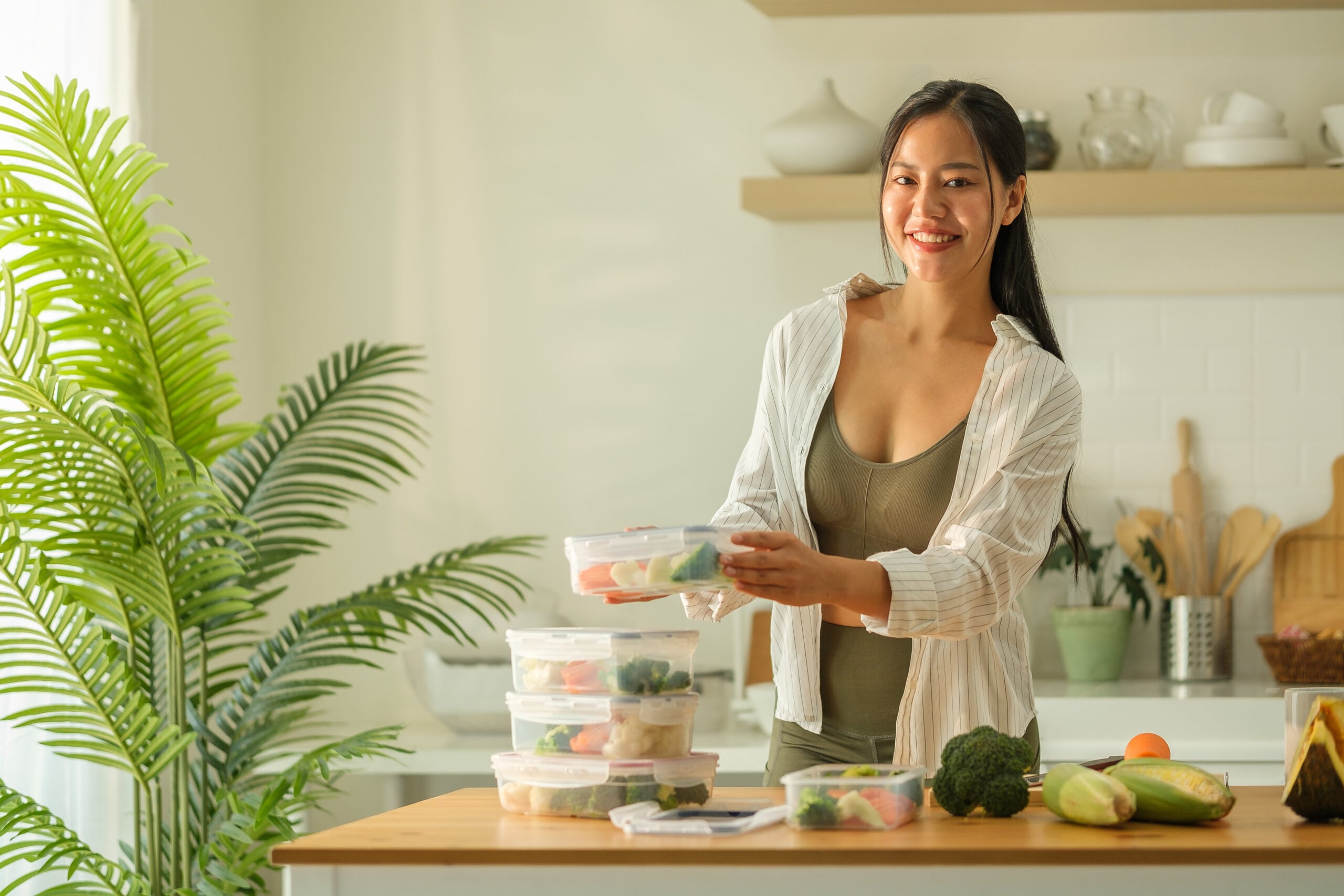 Meal prep containers of food arranged on a kitchen counter, ready for the week