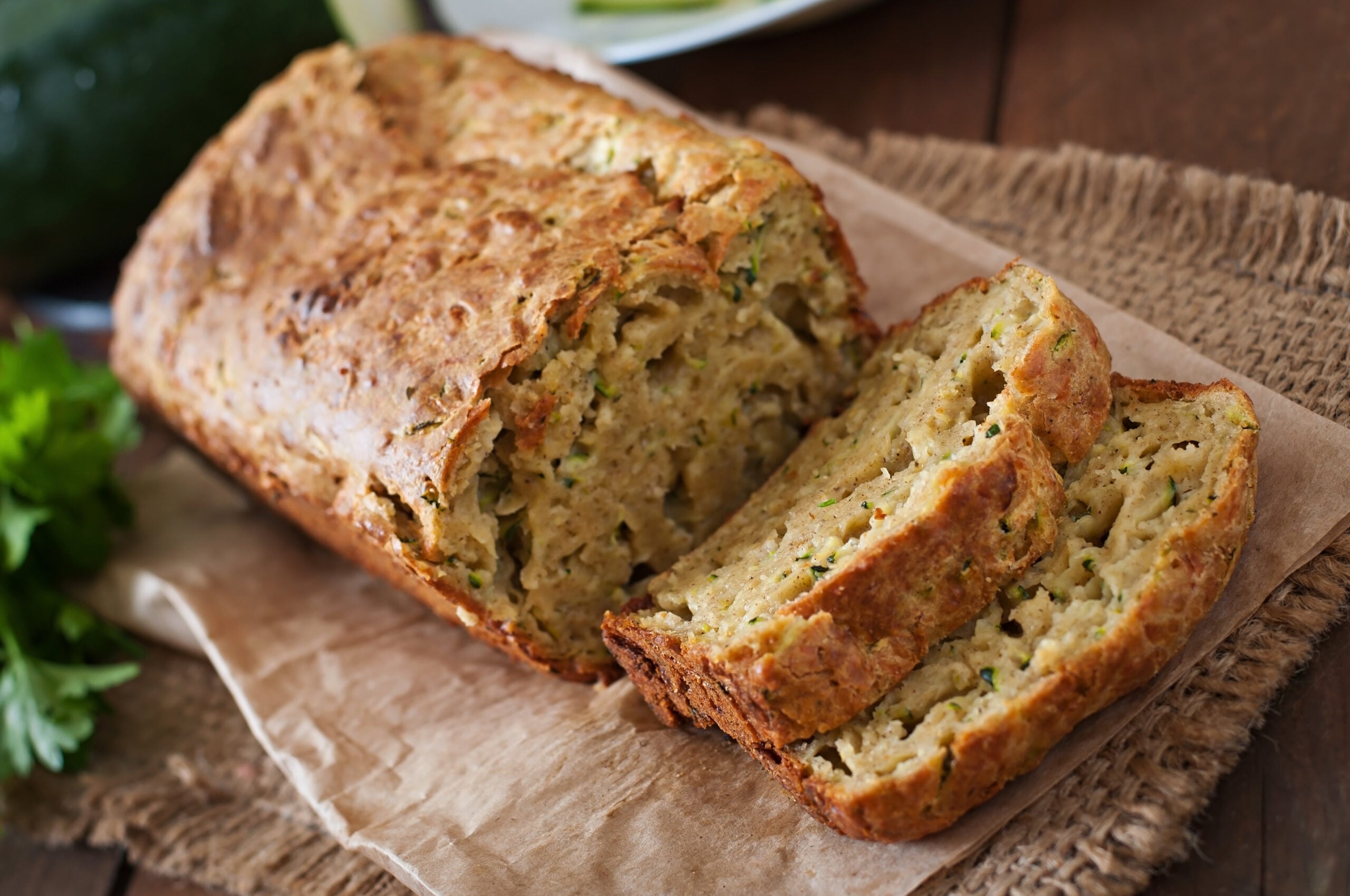 Sliced homemade zucchini bread on a wooden cutting board