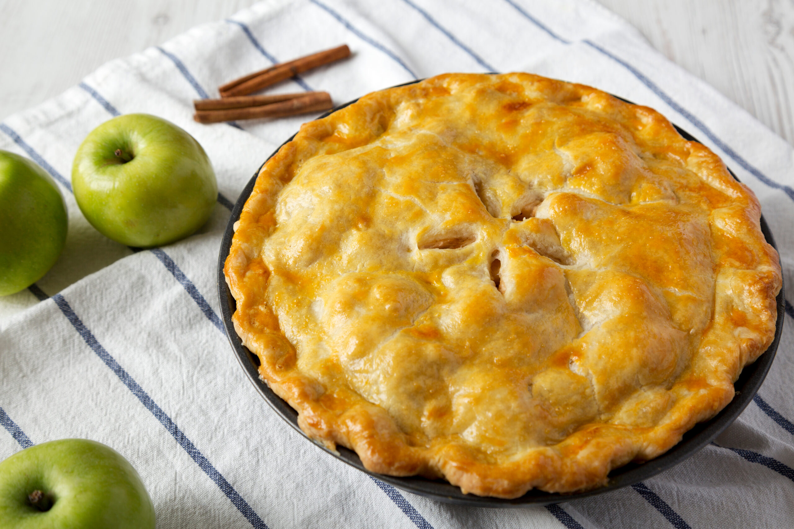 A homemade apple pie cooling on a linen cloth, baked from freezer apple pie filling