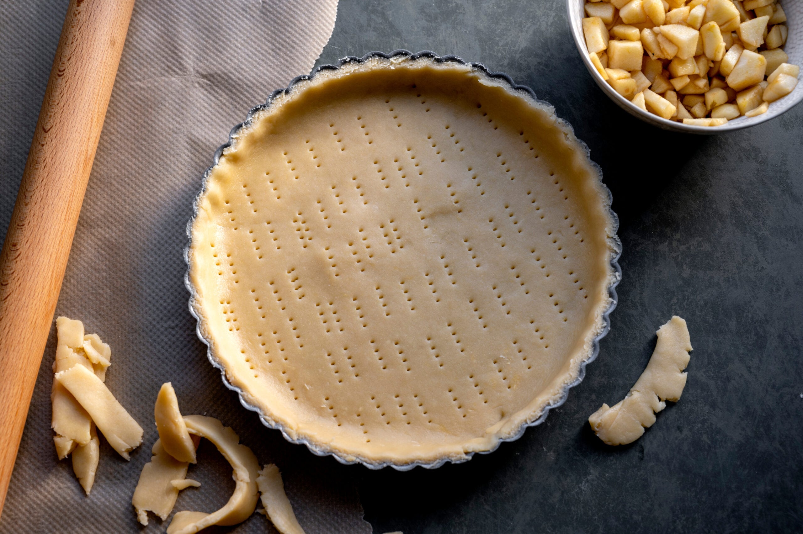 Unbaked all butter pie crust crimped into a glass pie plate ready for the freezer