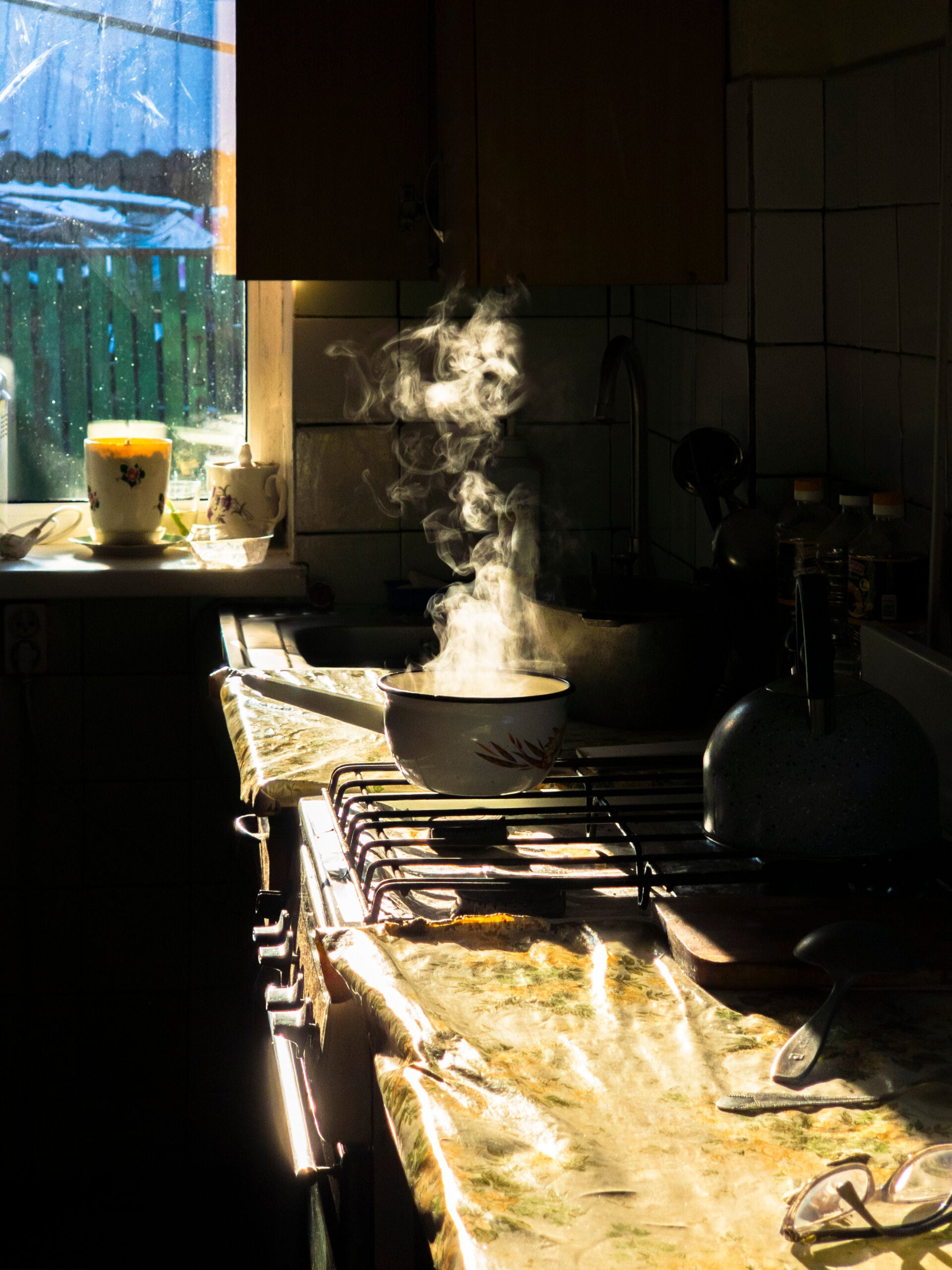 A pot simmering on the stove in a sunlit farmhouse kitchen, the start of a batch of from-scratch freezer meals