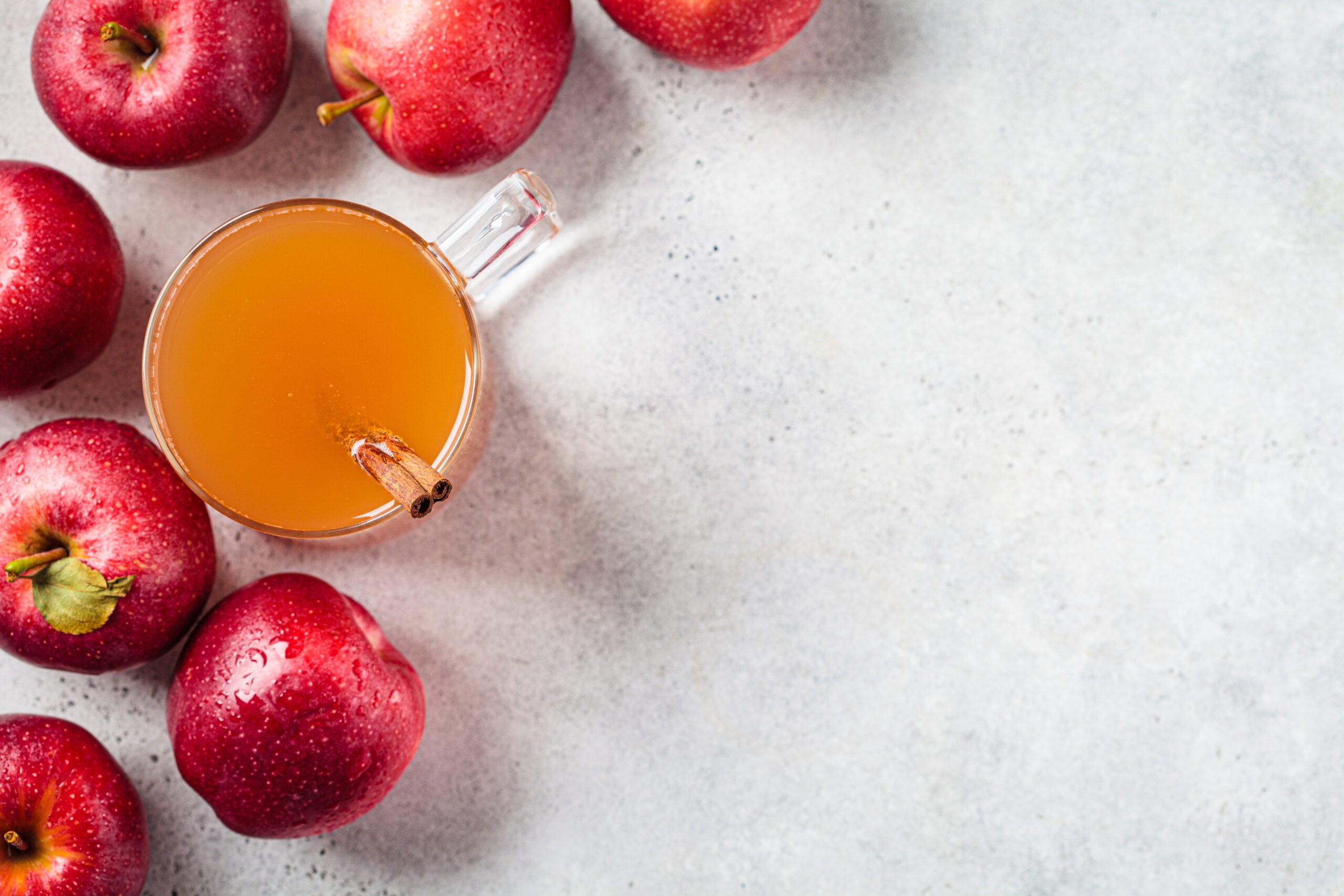 A warm cup of homemade apple cider served in a glass mug