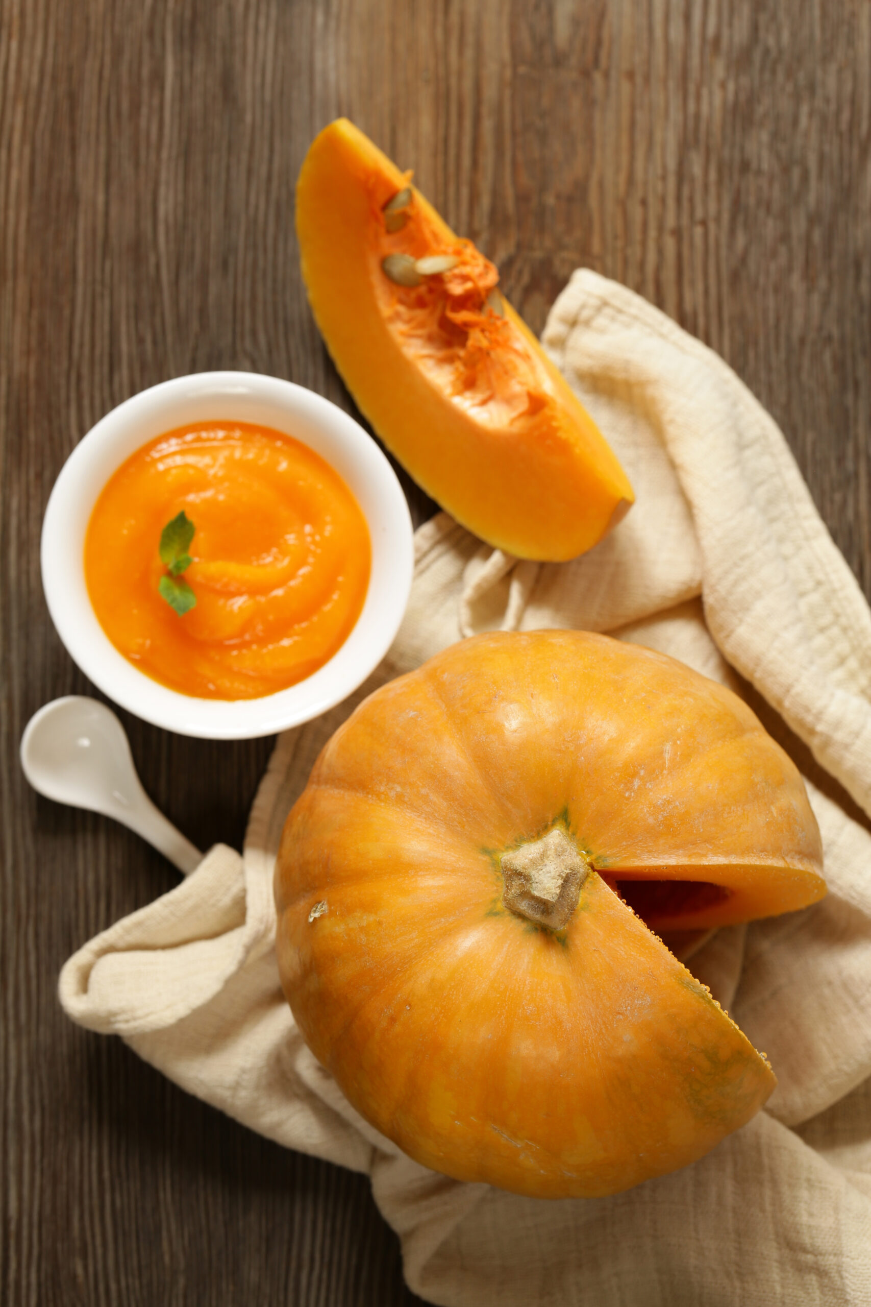 Thick homemade pumpkin puree in a bowl after straining off the extra water