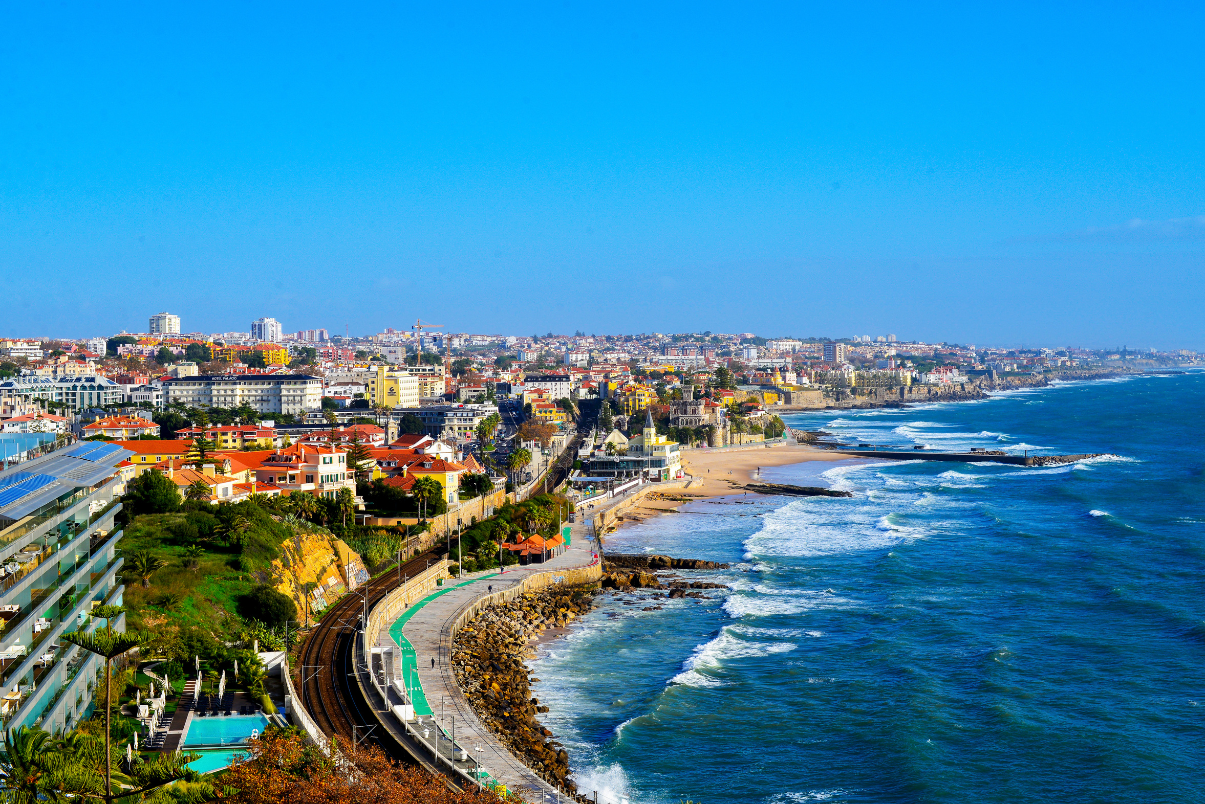 The flat coastline between Cascais and Estoril, Portugal, seen from above with the seafront promenade running along it