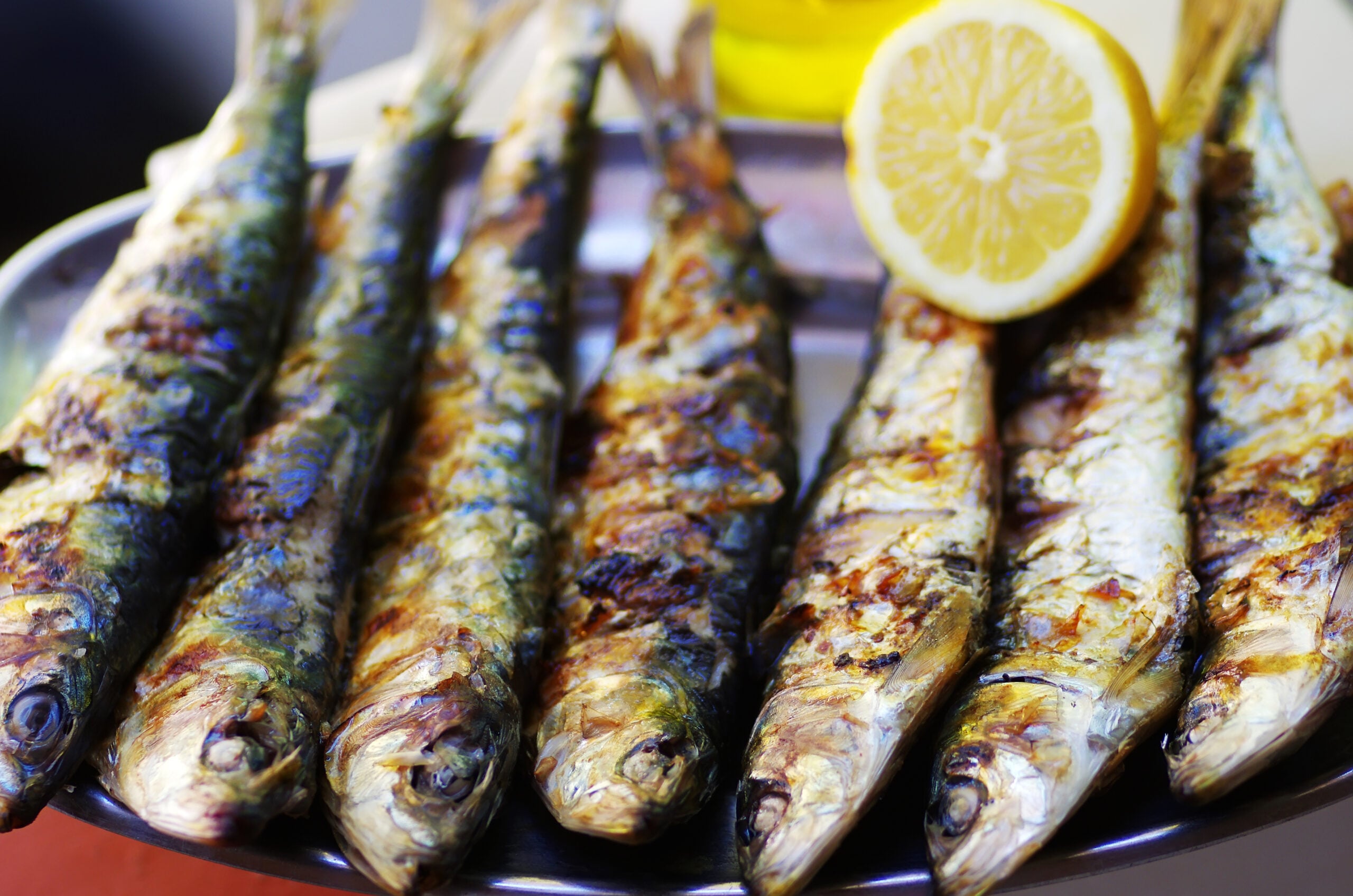 Grilled sardines served with lemon and olive oil, a simple Portuguese meal