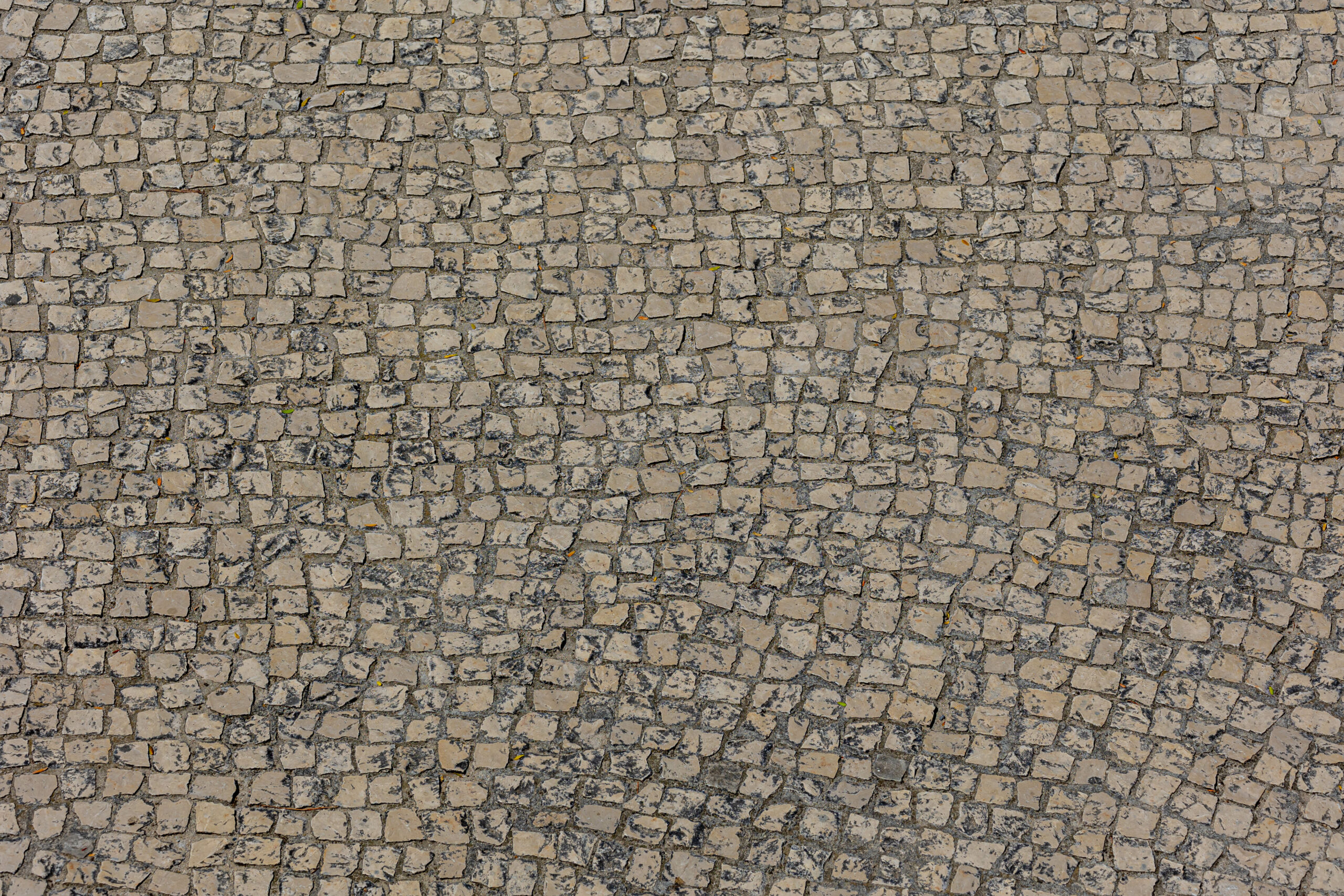 Traditional calcada portuguesa cobblestone paving on a footpath in central Lisbon