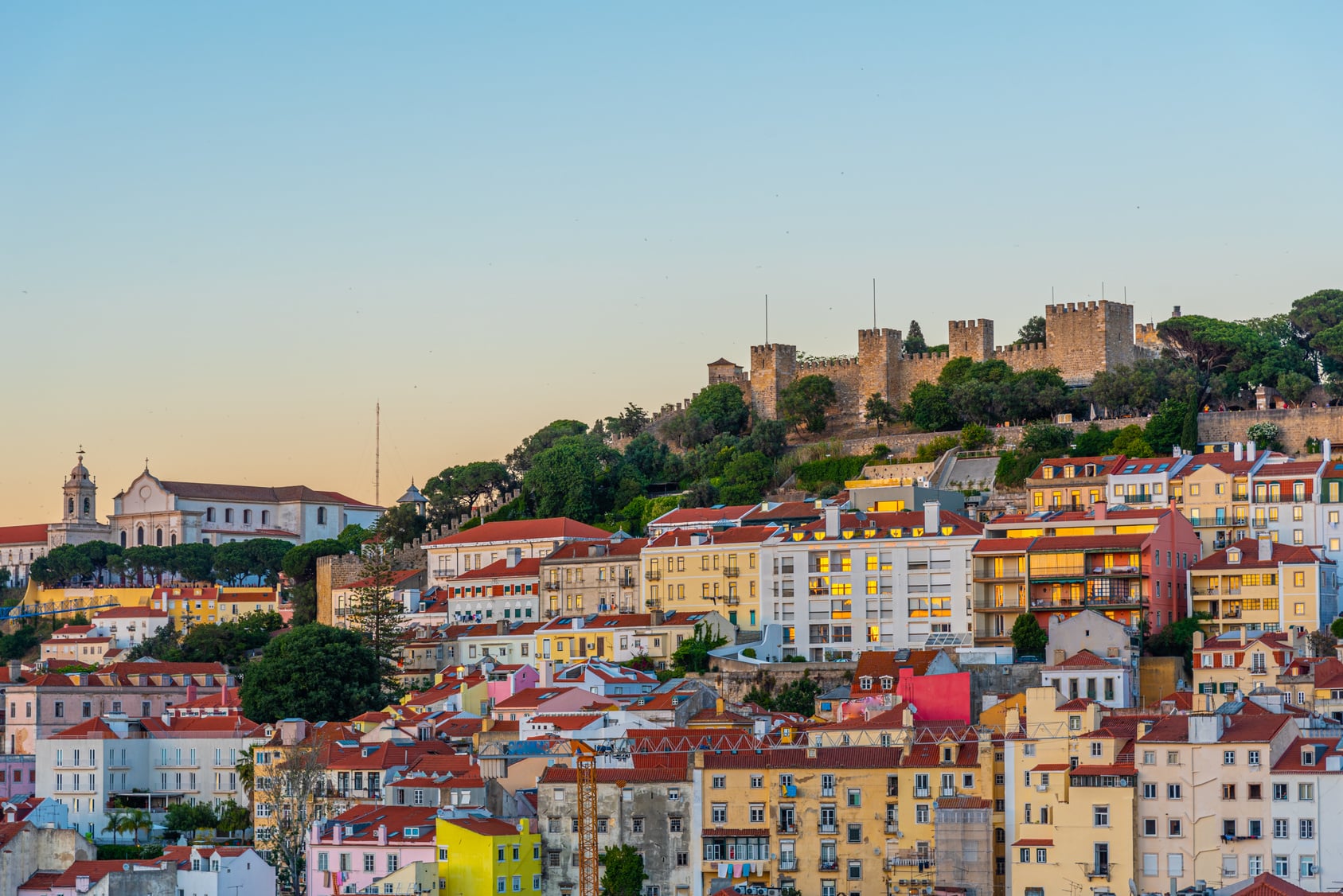 Sao Jorge Castle above the rooftops of Lisbon at sunset