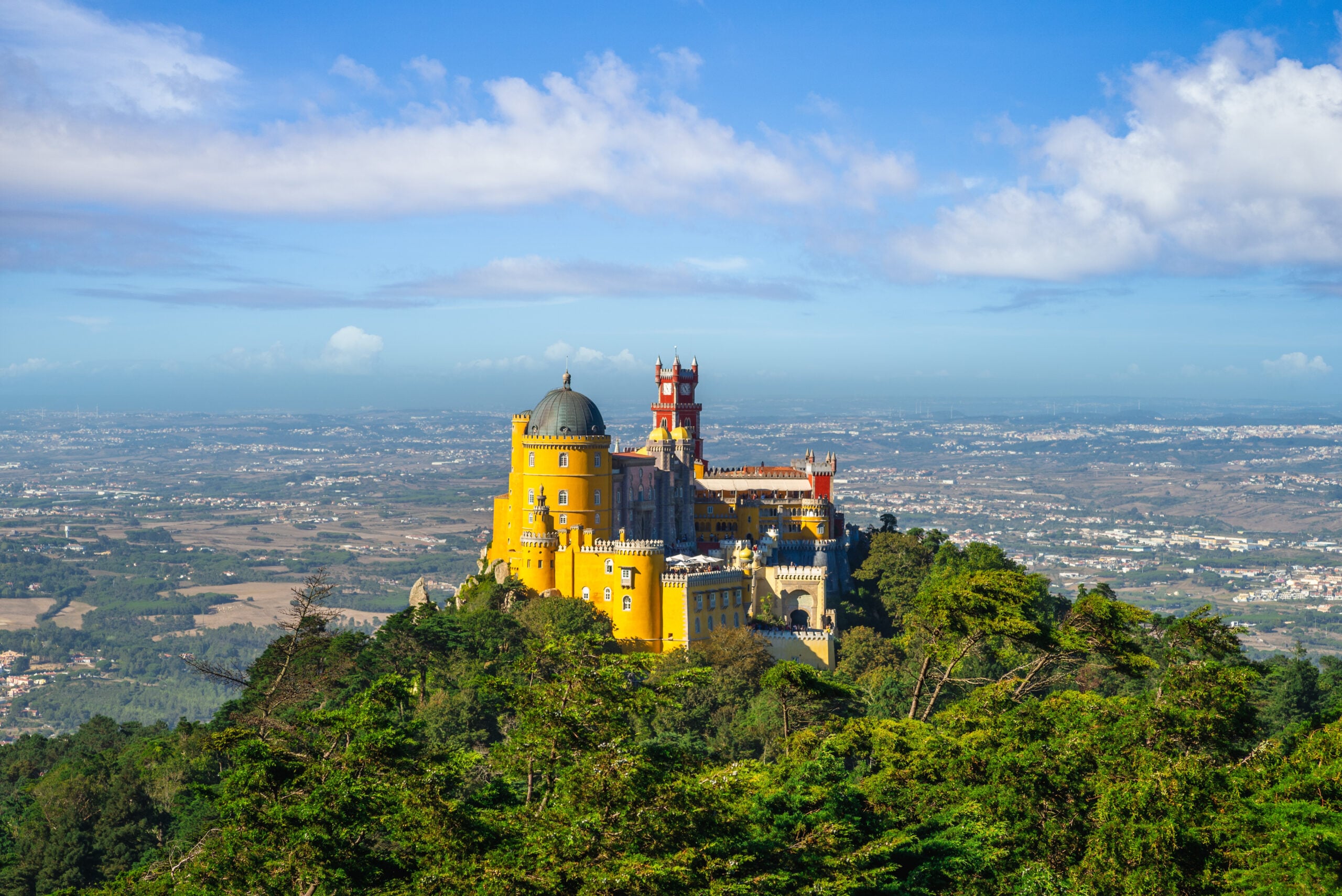 Pena Palace on the hilltop above Sintra, Portugal under full summer sun