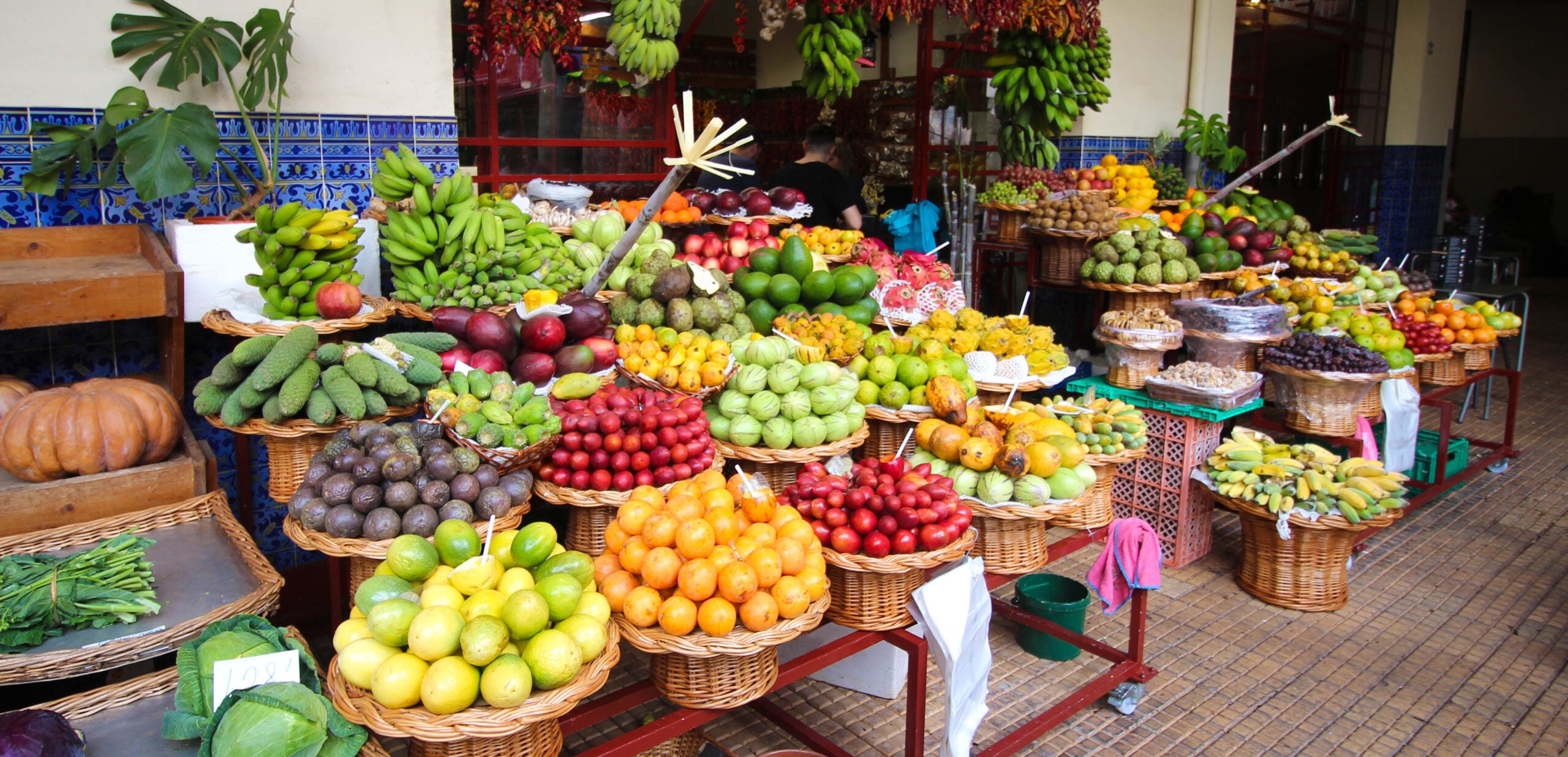 Stall piled with fresh fruit at the Mercado dos Lavradores market in Funchal, Portugal