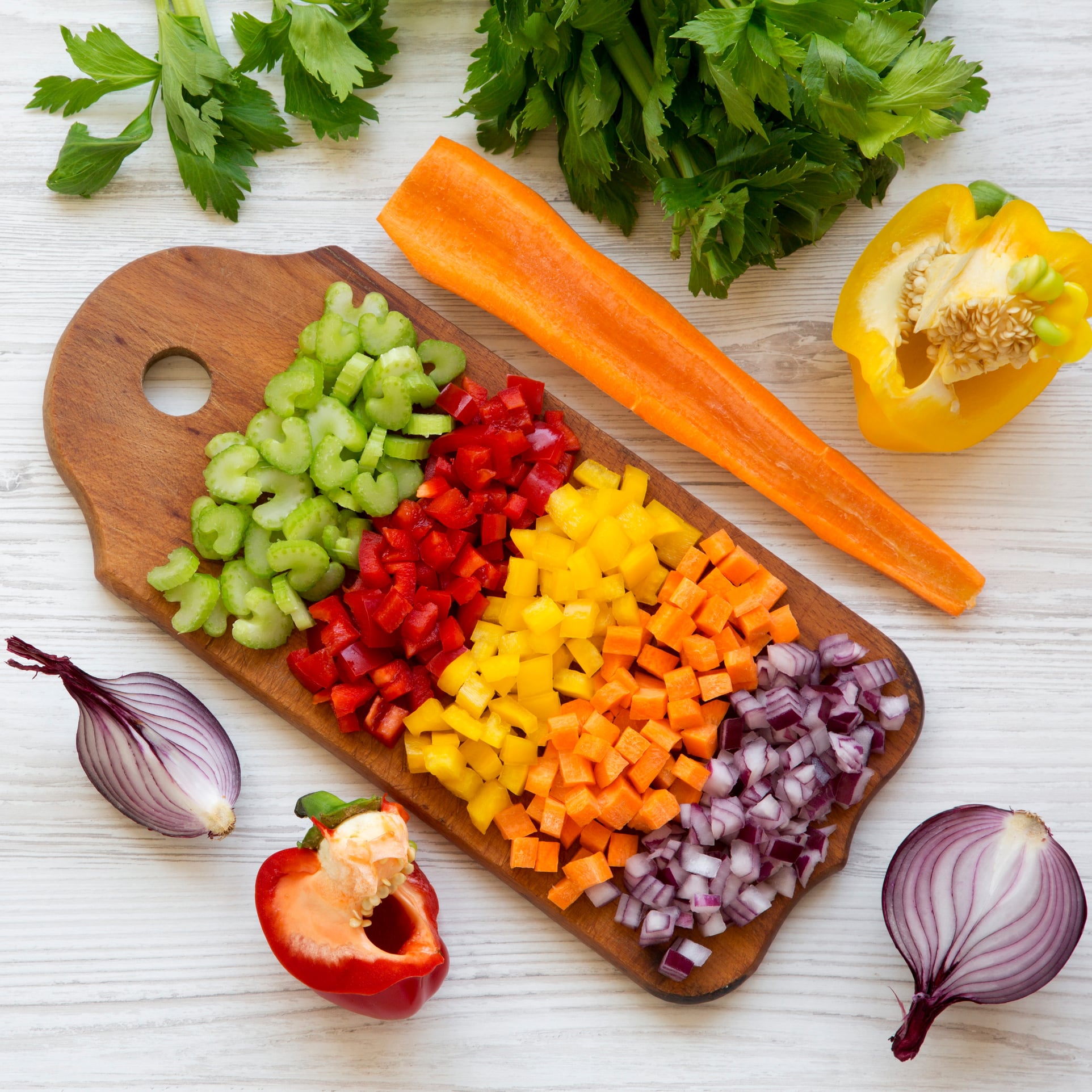 Chopped carrots, celery and onion on a cutting board for chicken pot pie filling