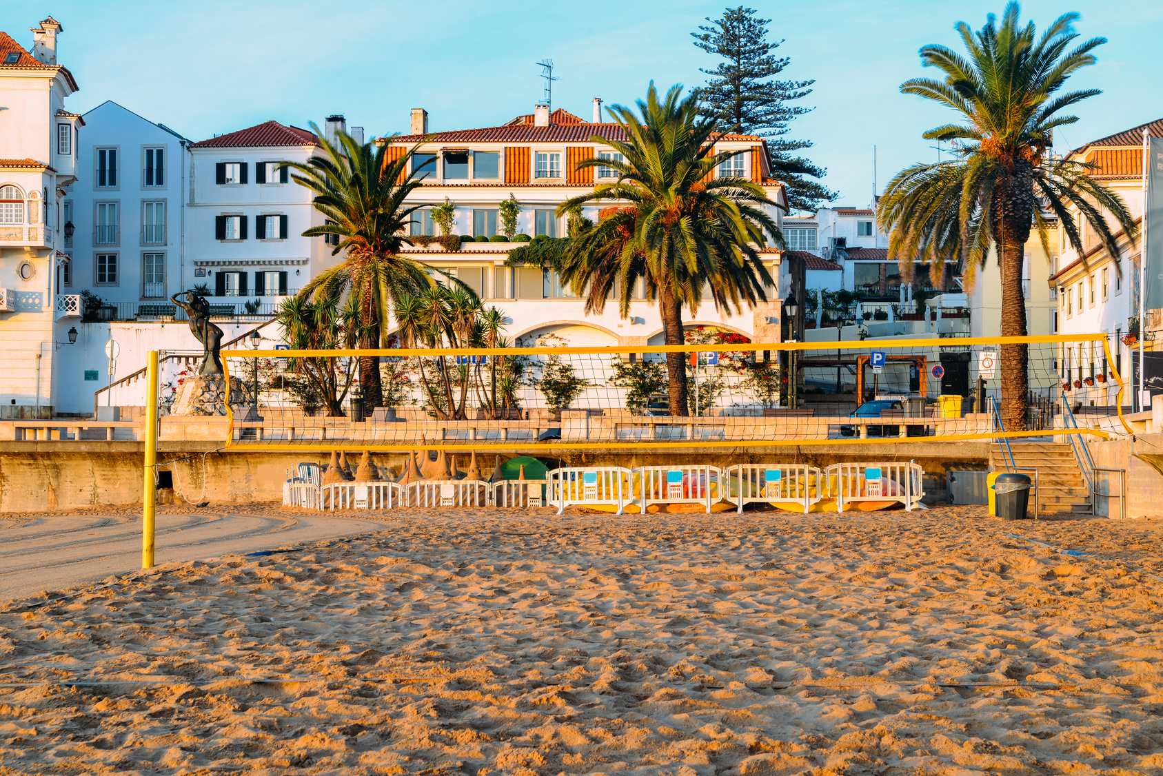 The small sheltered sand beach at Praia da Ribeira in Cascais, Portugal, empty just after sunrise