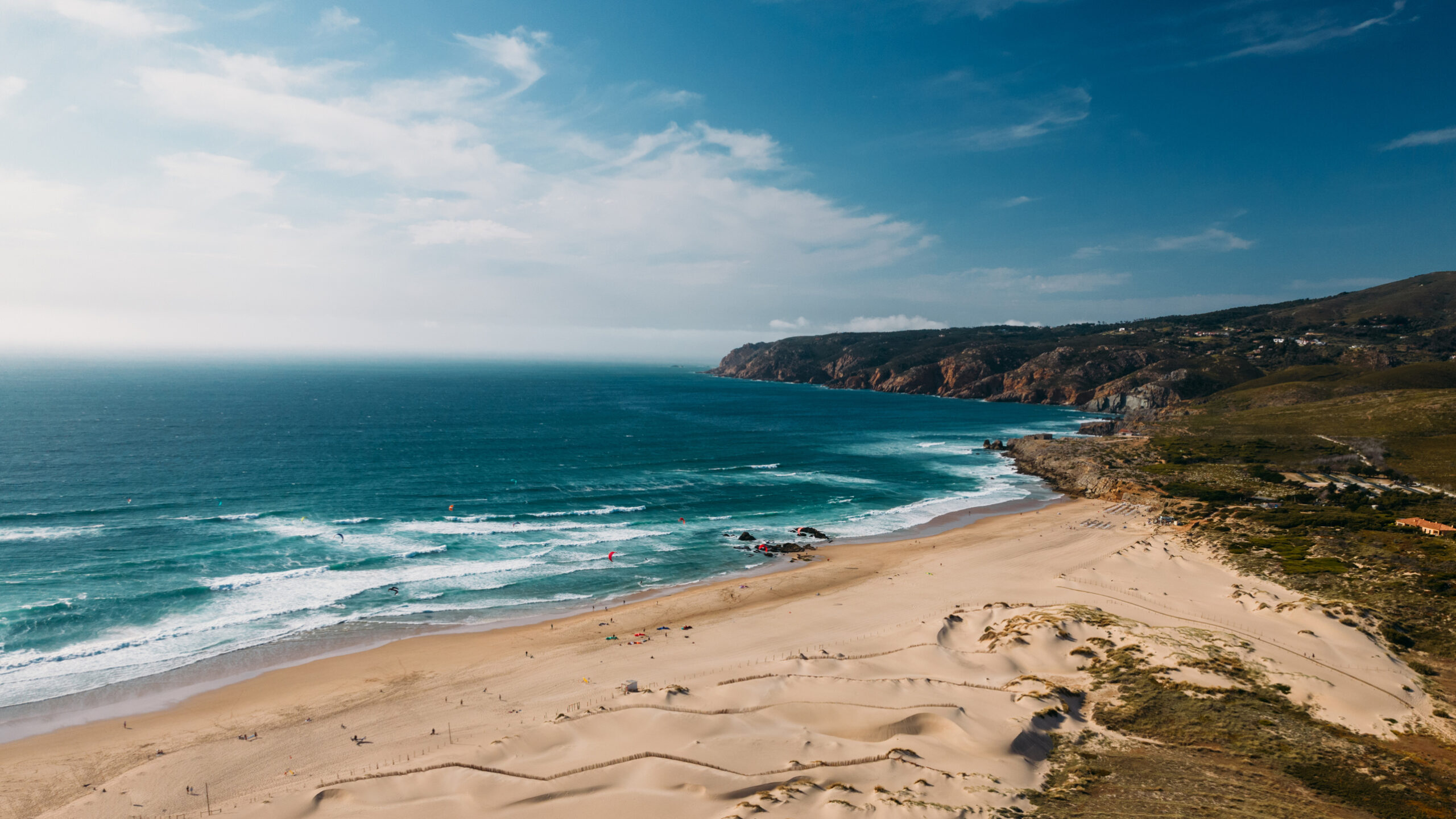 Kitesurfers out on the windy water at Praia do Guincho near Cascais, Portugal