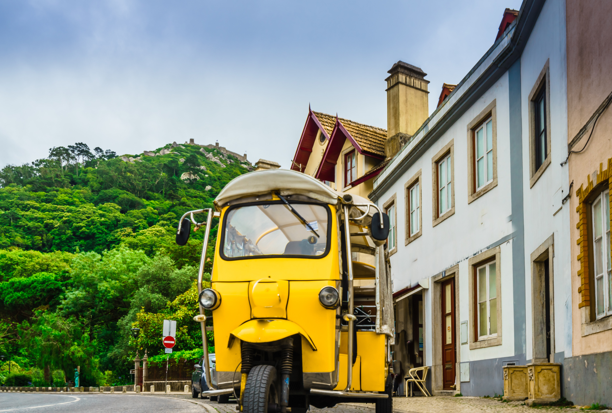 A tuk-tuk on a narrow street in the old town of Sintra, Portugal