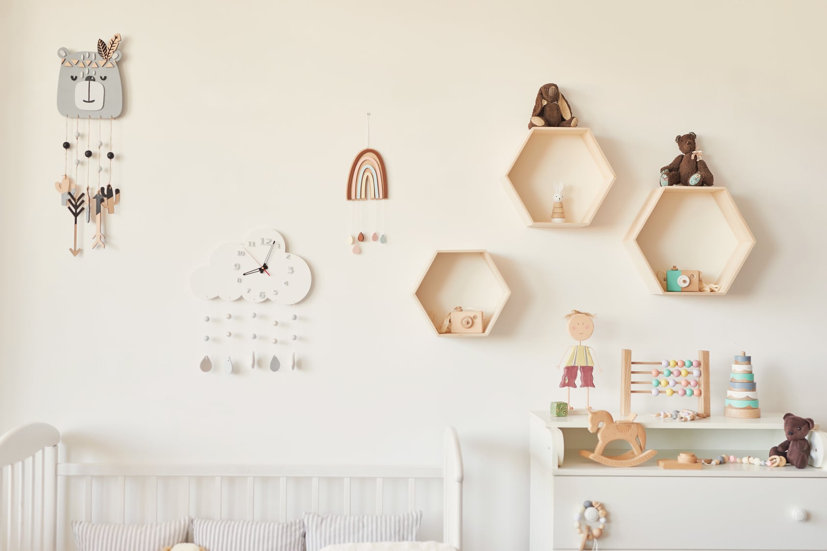 Wooden toys arranged on a low shelf in a child's bedroom, set up for a toy rotation